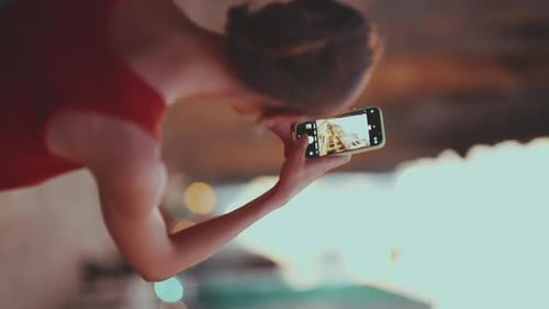 Close-up, girl takes pictures of downtown mobile phone