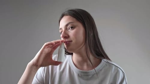Woman Using Nasal Spray for Health and Wellness