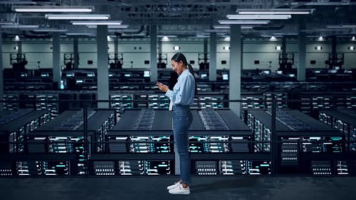 Side View Of Full Body Asian Business Woman Using Mobile Phone In Data Center