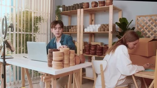 A young couple entrepreneur checking and packaging craft products selling