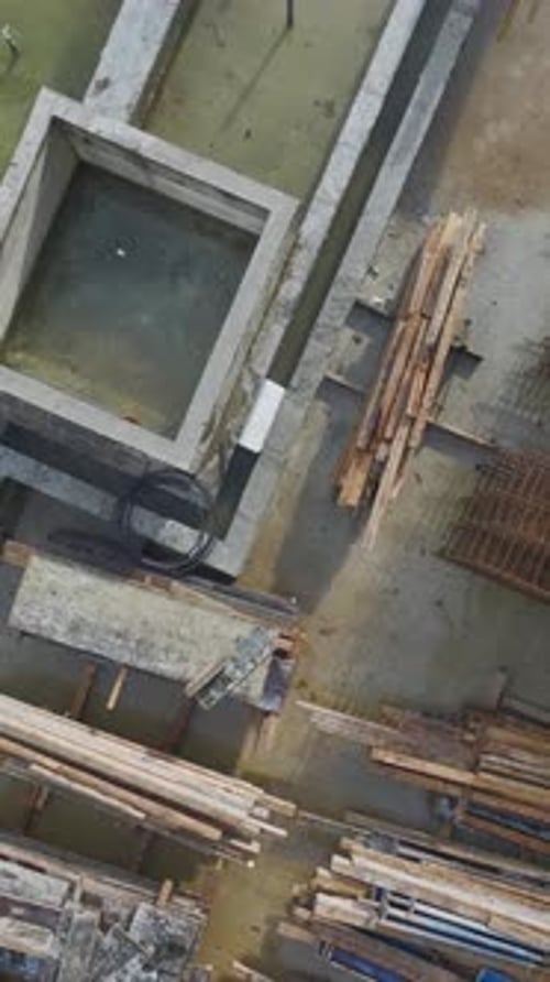 Vertical Video Construction Site Background With Workers Performing Various Tasks and Equipment in