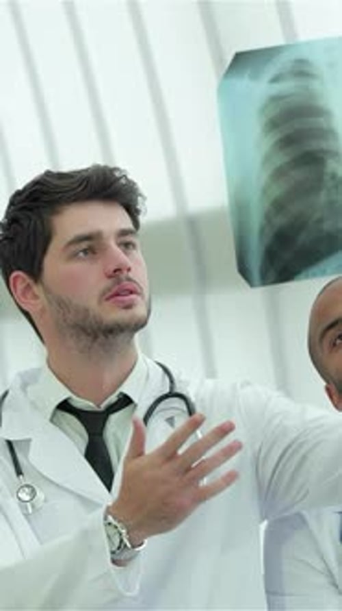 Three Confident Doctors Analyzing an Xray of Lungs in a Modern Hospital