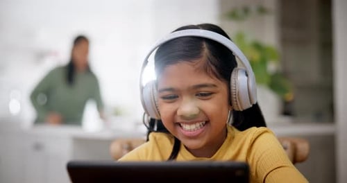 Girl Smiling Listening to Tablet with Headphones