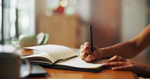 Hands Writing in a Notebook Indoors Daytime