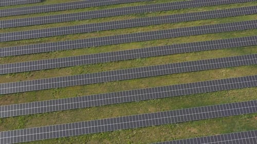 Aerial Shot of Rows of Energy Solar Panels Installed on Farmland Meadow or Rural Field Solar Panel