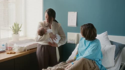 Newborn Infant Cared for by Mother and Nurse