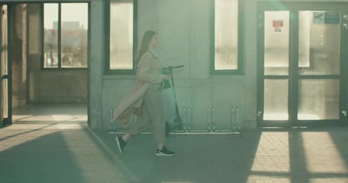 Woman Walks City Street with Drink