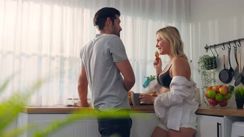 Loving Couple Sharing Breakfast in Bright Kitchen