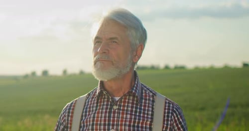 Farmer in a Plaid Shirt Tips His Hat