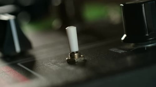 Person Flipping a Toggle Switch on and Off