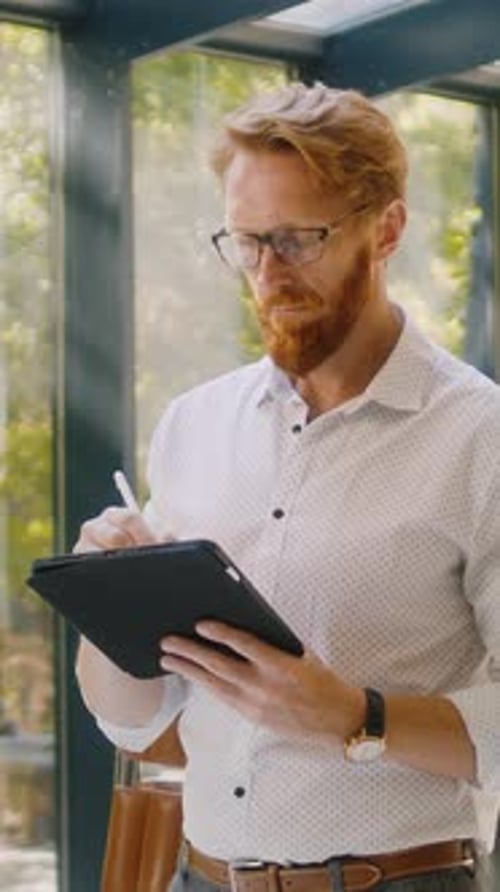 Man Using Tablet Device Indoors During Daytime