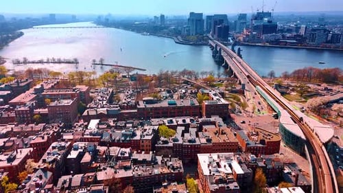 Approaching a waterfront of the Charles River and Longfellow Bridge above it.
