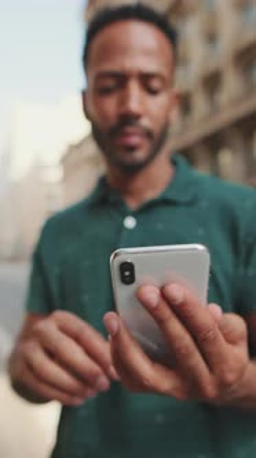 Close-up of the hands of young man using the phone