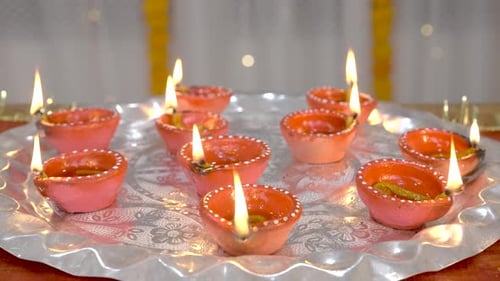 Glowing Diyas Oil Lamps on Silver Tray