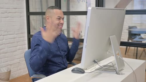 Man working at desk on computer in office
