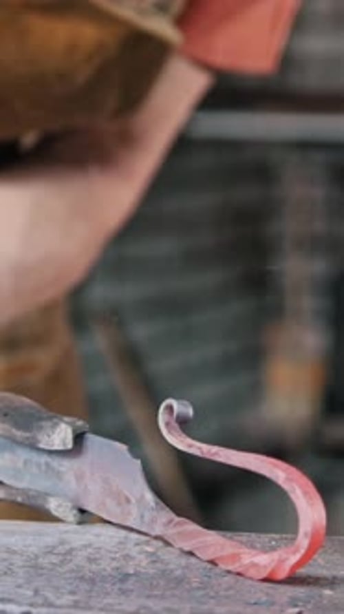 Craftsman Shaping Red Hot Metal with Hammer