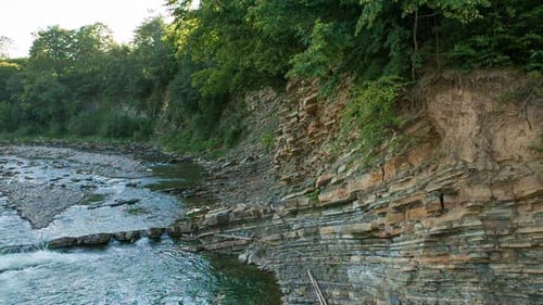 River Flowing Along Rocky Shore