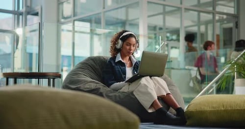 Laptop, typing and online class with woman in college for research, headphones and elearning