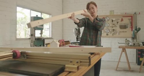 Worker young asian woman carpenter handle wood piece building design wooden working in workshop