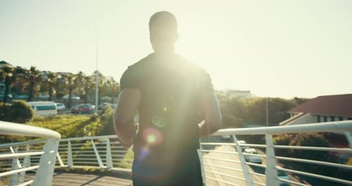 Running, fitness and back of man in city for training, health and cardio endurance