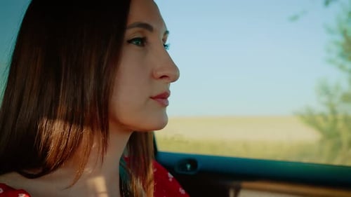 Woman Driving Car on Rural Road