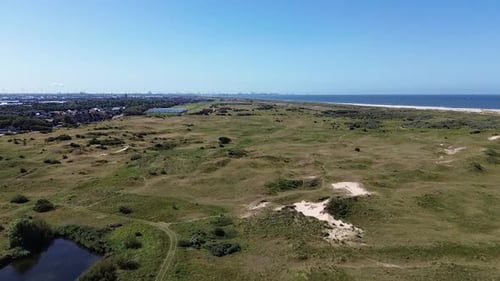 Aerial View of Coastal Dunes and Blue Ocean