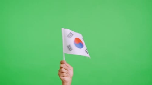 Hand Holding South Korean Flag on Green Screen