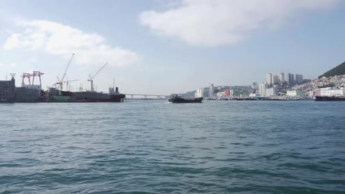 The Port of Busan and a ship crossing Busan Harbor