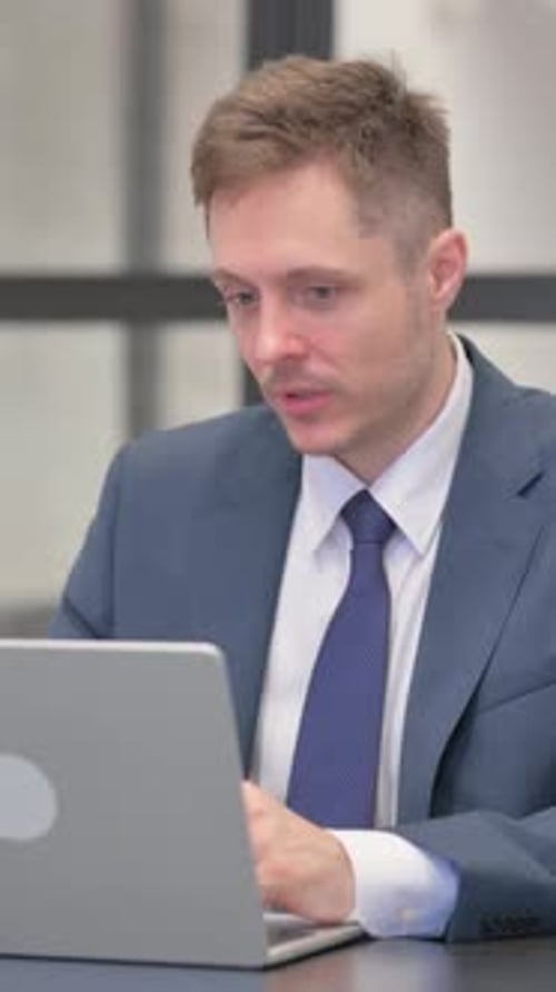 Businessman Talking During Video Conference in Office