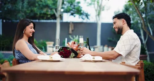 Romantic Young Couple Celebrating with Champagne Outdoors