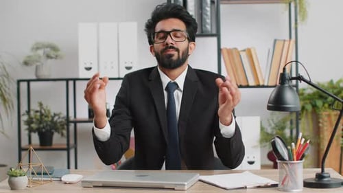 Businessman Working on Laptop Meditating Doing Yoga Breathing Exercise in Lotus Position at Office