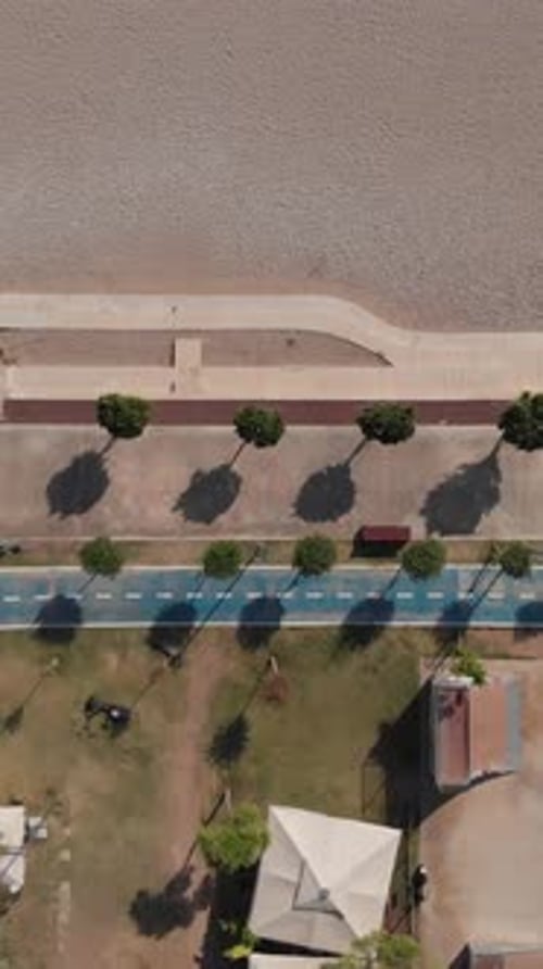 Drone Top Shot Flying Sideways Over Modern Promenade on Mediterranean Coast