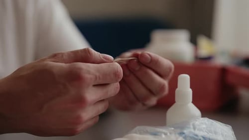 Hands Separating a Cotton Pad Close Up