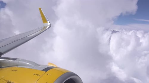 Airplane Wing Soaring Through the Clouds