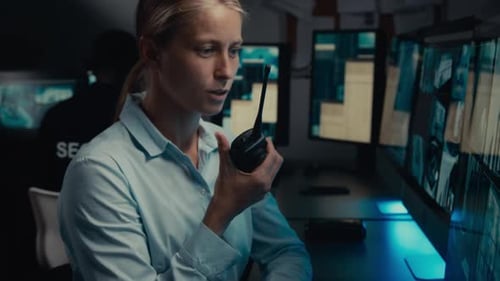 Woman Security Guard Talking on Walkie Talkie