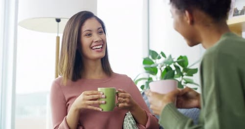 Two Women Conversing at Home with Mugs