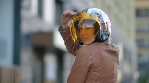 Woman Lifts Motorcycle Helmet Visor in City