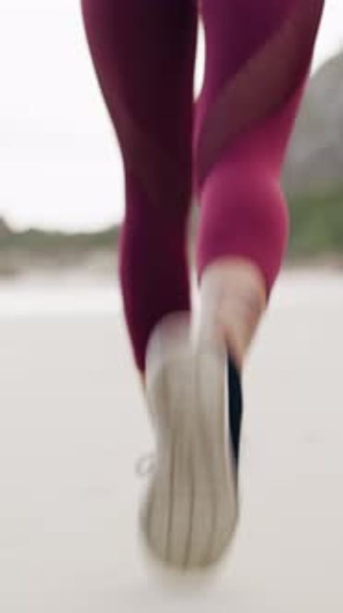 Fitness, running and legs of woman on beach for workout, challenge or training with sports wellness