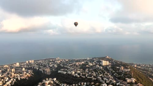 Hot air balloon above Haifa bay and Downtown area at sunrise, Aerial view