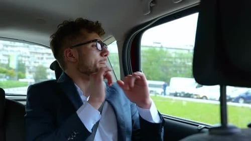 Man Riding in Car, Talking and Gesturing