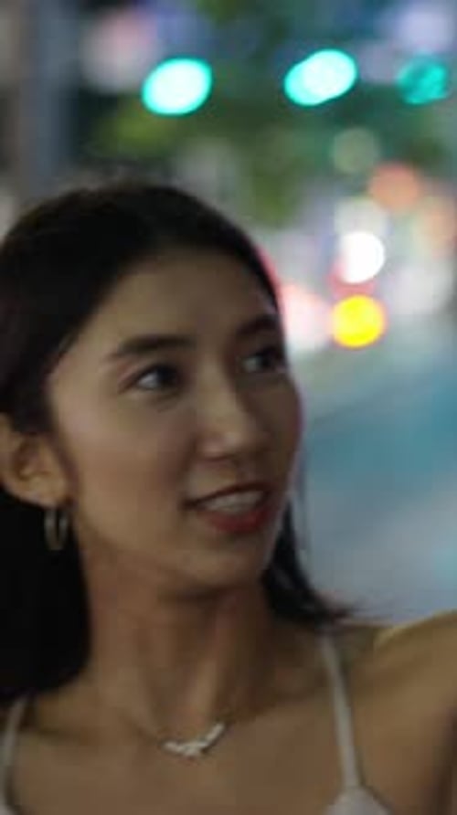 Woman Takes Selfie at Night in City