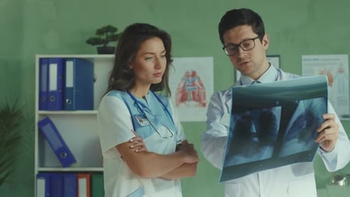Doctors Examining X-Ray in Medical Office