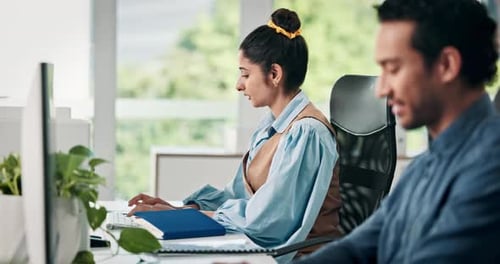 Professionals working at computers in a modern office