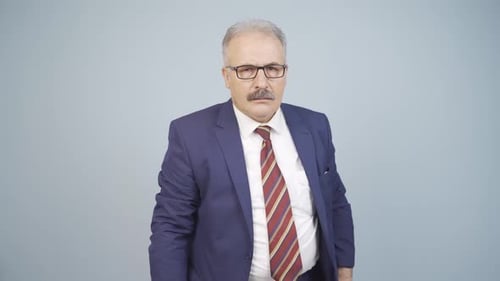 Man in Suit Looking at Camera Seriously