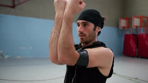 Athlete Moves Arms Biceps After Warming Up Basketball Court