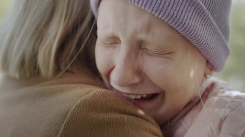 The Child Cries on the Shoulder of the Mother Very Upset Tears Flow