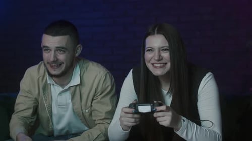 Couple Laughing and Playing Video Games at Home