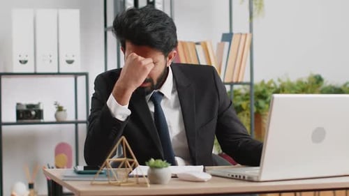 Tired Indian Business Man Suffering From Headache Problem Tension Migraine Stress at Home Office