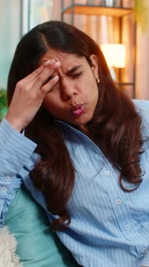 Indian Woman Touching Head with Tension and Pain From Headache at Home Exhausted and Uncomfortable