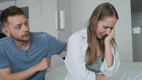 Man Comforts Woman in Home Interior